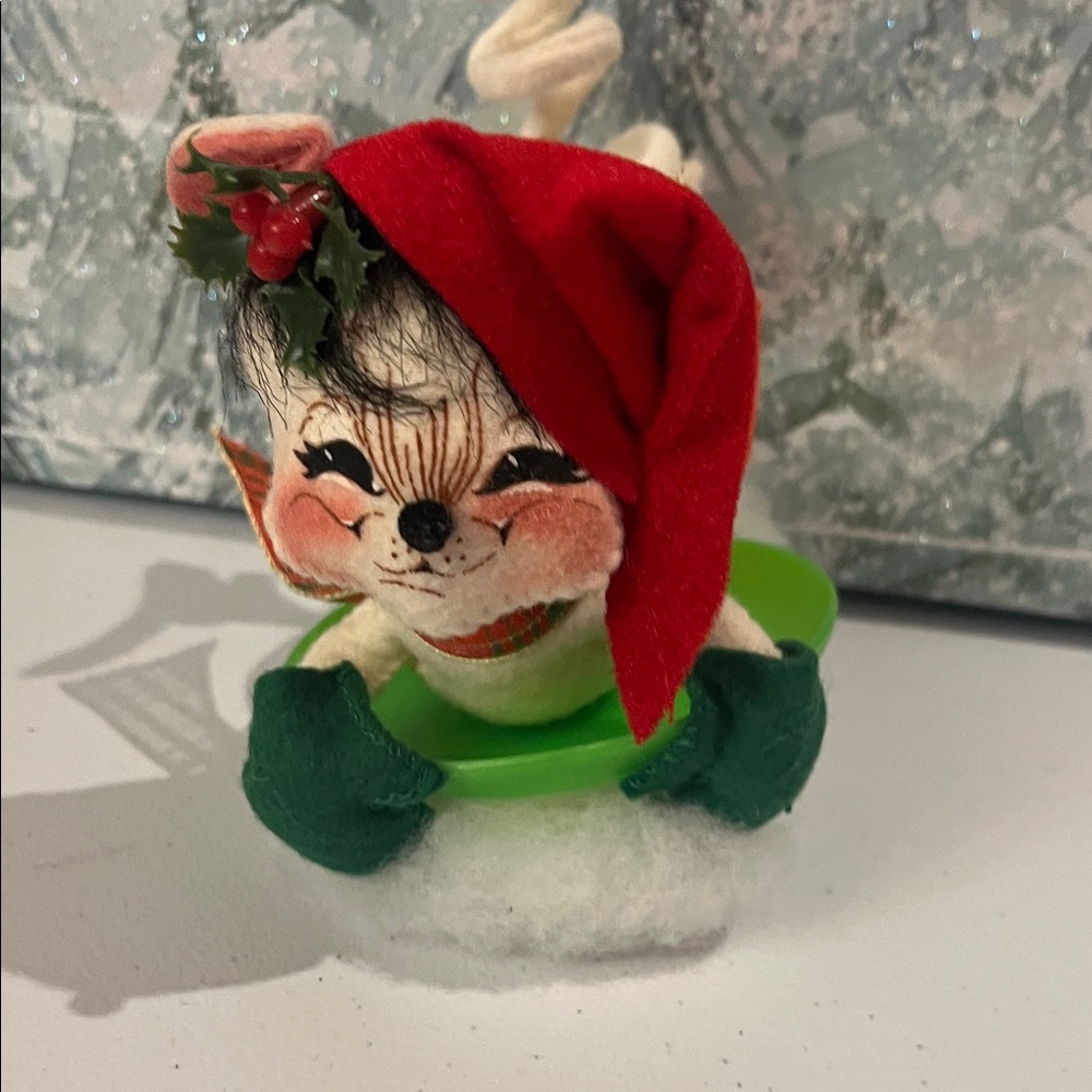 This is an Annalee Mobilitee Dolls 7" Sledding Mouse on a saucer.